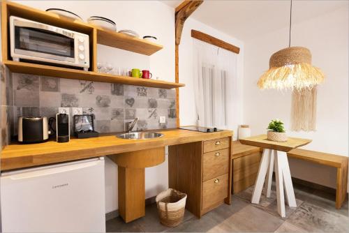 a kitchen with a sink and a microwave at Ziv Boutique Apartments Town Square in Lefkada Town