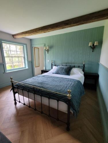 a bedroom with a large bed in a room at The Coach House in Carlisle