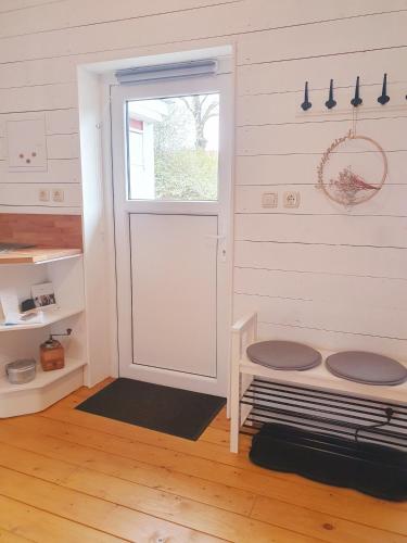 a room with a door and a window and wooden floors at Ferienhaus Svensson Altheide in Altheide
