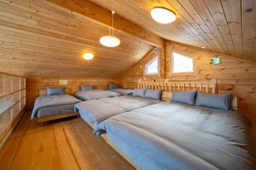 a room with three beds in a wooden cabin at The Crestview Lodge 
