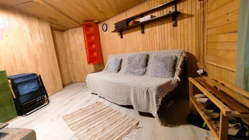 a small bedroom with a bed and a tv at Chata pri 7 jazerách s vyvýšenou terasou in Štiavnické Bane
