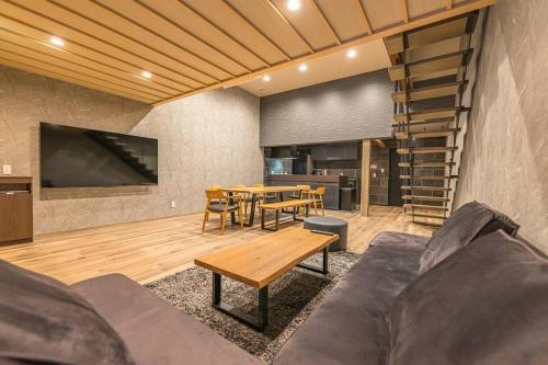 a living room with a couch and a table at 香季庵Euphoria in Sado