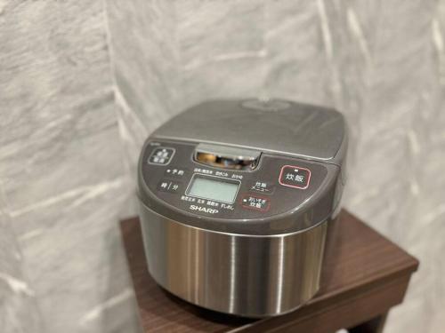 a small appliance sitting on a wooden table at 香季庵Euphoria in Sado