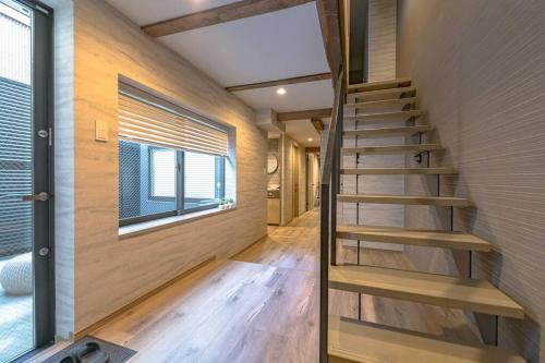 a staircase in a tiny house with a window at 香季庵Euphoria in Sado