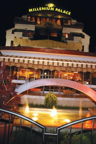 a building with a white bridge in front of it at Millenium Palace in Ohrid