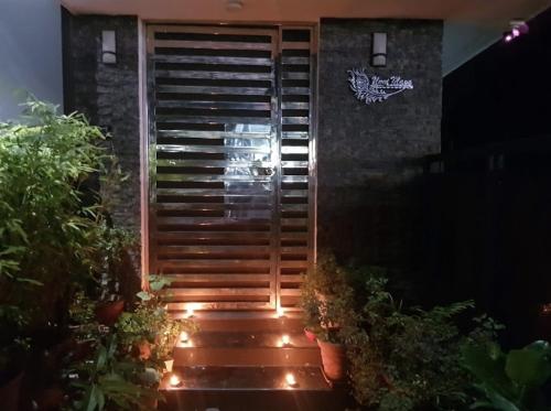 a set of stairs with lights in front of a building at Unnimaya in Kattakkada