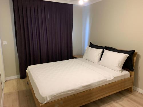 a bedroom with a bed with white sheets and pillows at AHG Atlas Apartments in Istanbul