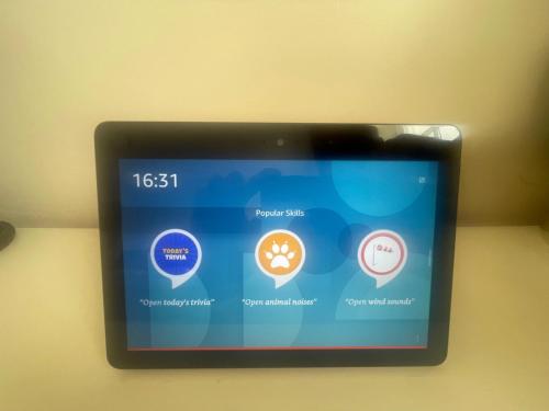 a tablet screen with icons on a wall at Leamington Loft in Leamington Spa