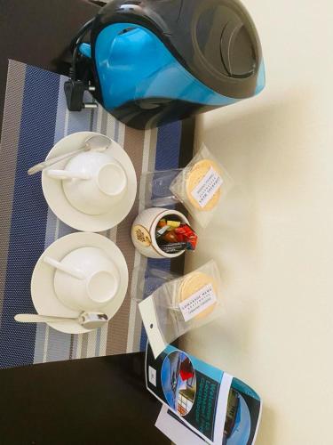 a close up of a table with a light and containers at Lormasol Mews Guesthouse in Serowe