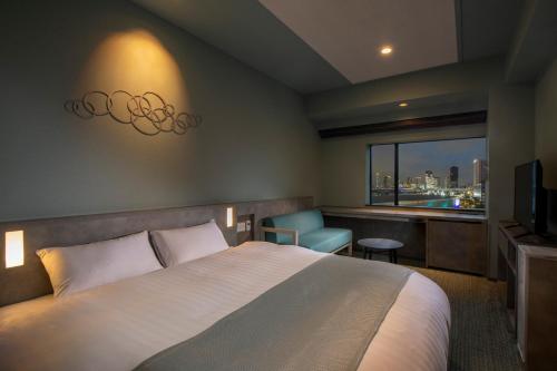 a hotel room with a bed and a window at La Vista Tokyo Bay in Tokyo