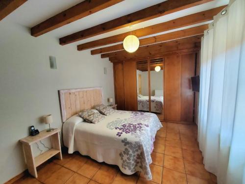 a bedroom with a bed in a room with wooden ceilings at La Panera in San Vicente de la Barquera