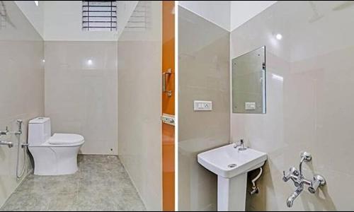 a white bathroom with a toilet and a sink at FabHotel The Cute in Bangalore