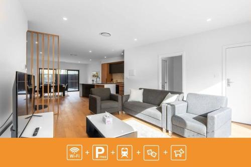 a living room with two couches and a tv at O‘Connor 3 bedroom Townhouse in Canberra in Canberra
