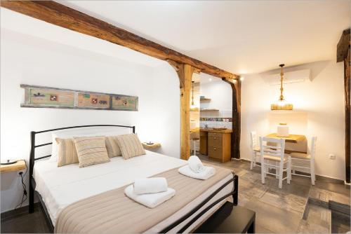 a bedroom with a bed with two towels on it at Ziv Boutique Apartments Town Square in Lefkada Town