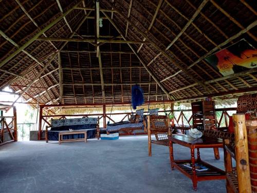 a large room with tables and chairs in a building at Karibu Paradaizi in Michamvi