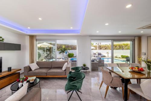 a living room with a couch and a table at Fig Tree Bay Residences 3 in Protaras