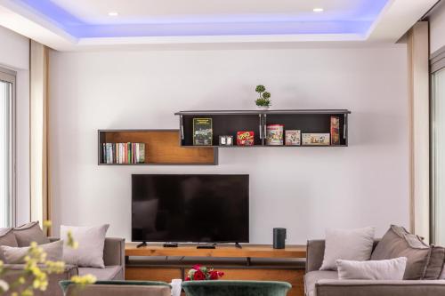 a living room with a flat screen tv on a wall at Fig Tree Bay Residences 3 in Protaras