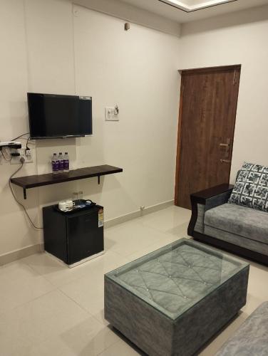 a living room with a couch and a table at ANNAI RESIDENCY in Vellore