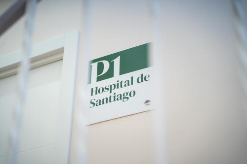 a sign for the hospital die santiago on a wall at El Secreto de Chirinos in Úbeda