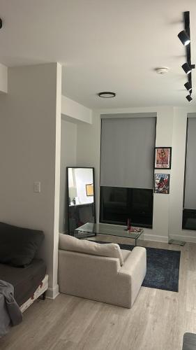 a living room with a couch and a large screen at Studio Ottawa in Ottawa