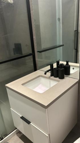 a bathroom counter with a sink and a mirror at Studio Ottawa in Ottawa