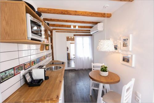 a kitchen with a counter and a table in a room at Ziv Boutique Apartments Town Square in Lefkada Town