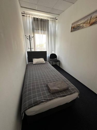 a bedroom with a bed in a room with a window at Aleja "Solidarności" in Warsaw