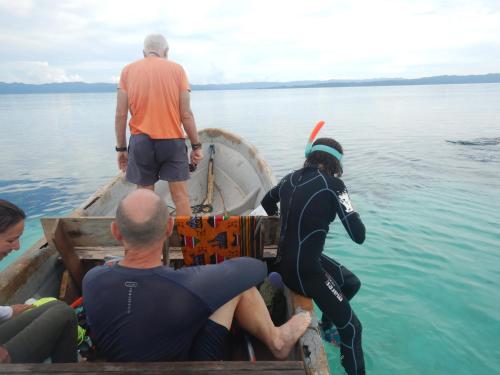 a group of people on a boat in the water at Raja Ampat Blue Sea in Besir