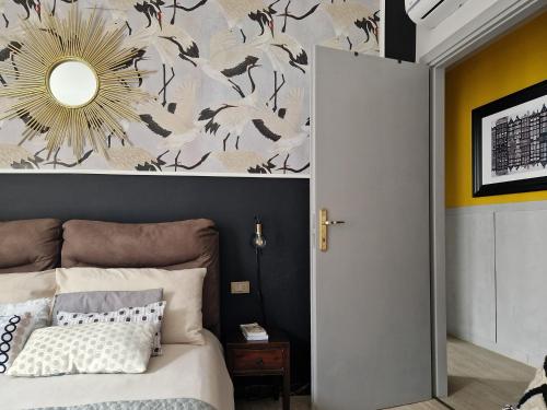 a bedroom with a bed and a wall with a mirror at Acquadolce in Salò