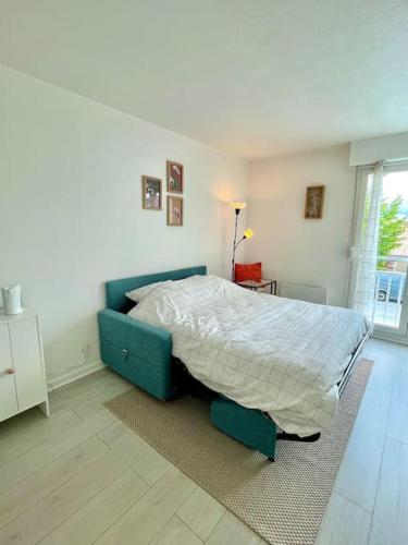 - une chambre dotée d'un lit avec un cadre bleu dans l'établissement Studio cozy au cœur de Bordeaux, à Bordeaux