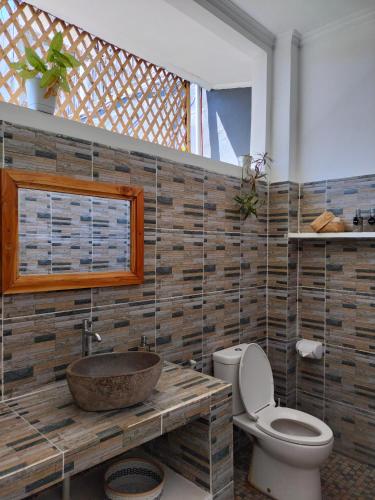 a bathroom with a sink and a toilet at Bali Diversity Dive Resort in Amed