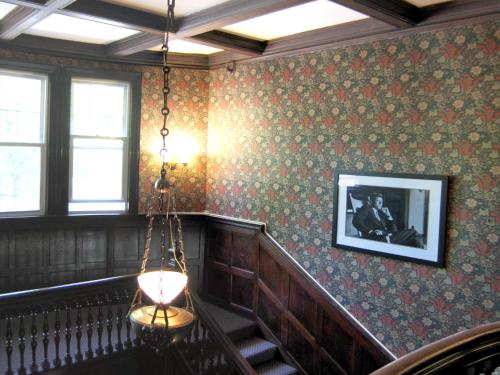 a room with a staircase with a picture on the wall at Longwood Inn in Brookline