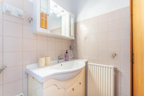 a bathroom with a sink and a mirror at Lotus Apartment 4 in Almiros Beach