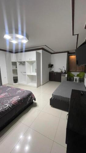 a large room with a bed and a couch at aljazeera apartments in Amman