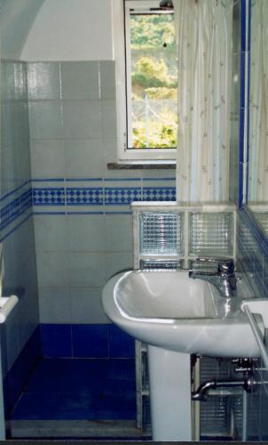 a white sink in a bathroom with a window at L'Isolana Case Vacanza Alloro 3 in Ponza