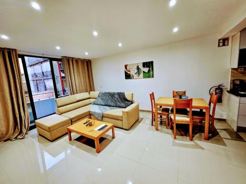 a living room with a couch and a table at Flamingo Plateau 1A apt on Rua Pedonal Praia Cape Verde in Praia