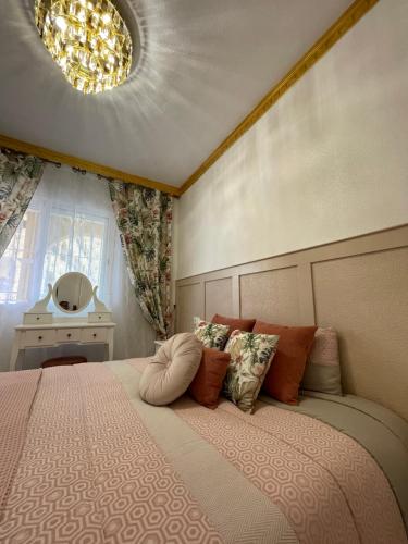 a bedroom with a large bed with pillows on it at Casa Amarela Guesthouse, Algorfa in Algorfa