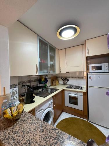 a kitchen with white appliances and a counter top at Casa Amarela Guesthouse, Algorfa in Algorfa