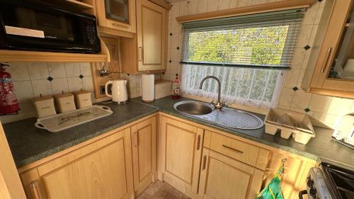 a small kitchen with a sink and a window at Getaway House in Clacton-on-Sea