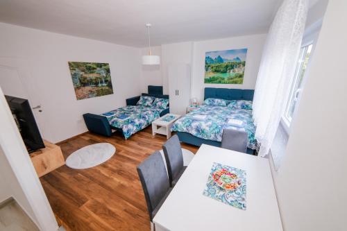 a living room with a bed and a table at Apartman Neca Trebinje in Trebinje