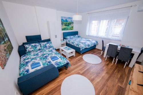 a living room with a bed and a table and a dining room at Apartman Neca Trebinje in Trebinje