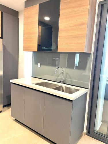 a kitchen with a sink and wooden cabinets at Aquanique Luxury Living in Dakar