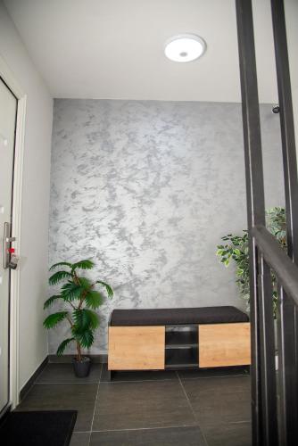 a room with a bed and a wall with plants at Čudna šuma apartmani Vrdnik in Vrdnik