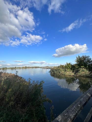 a view of a river under a cloudy sky at Het Spoel in Kuilenburg