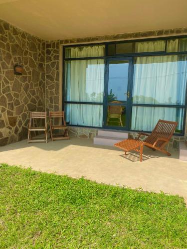 a patio with a rocking chair and a window at Spice of Ceylon in Chilaw
