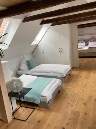a room with two beds and a table in it at Nicolai Suite - Schrangen-Suites-1389 in Lüneburg