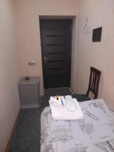 a room with a bed with a computer mouse on it at CTH-Baku-Hostel in Baku