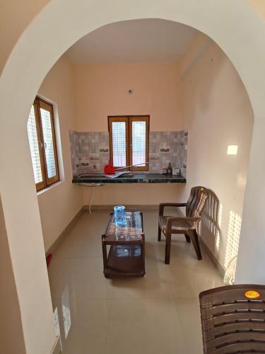a living room with a table and a chair at Rahgir Guest House in Almora