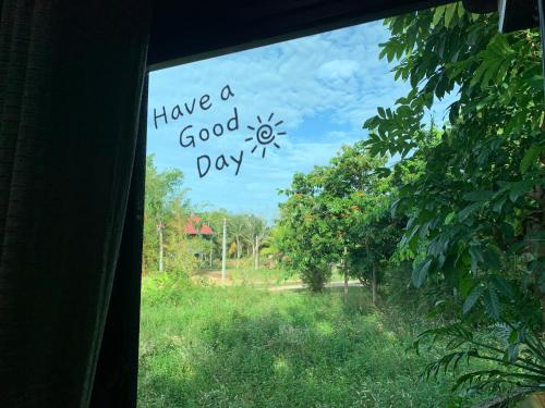a window with a sign that reads have a good day at Wooden House,Rustic charm in quiet area in Ban Khlong Chi Lat
