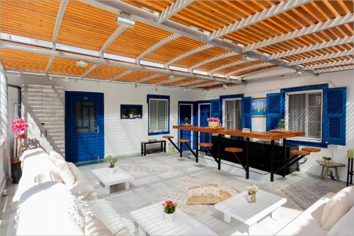 an outdoor patio with a table and a couch at Ziv Boutique Apartments Town Square II in Lefkada Town